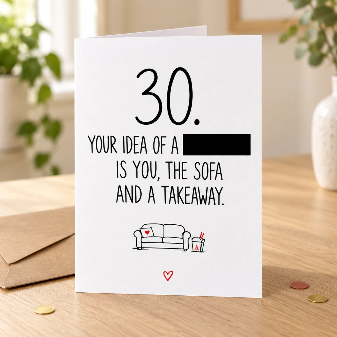 Lifestyle mock-up of a standing 30th birthday card with a sofa and takeaway doodle. One word in the joke is covered by a black bar. The card stands on a wooden table beside a kraft envelope and red/gold confetti.