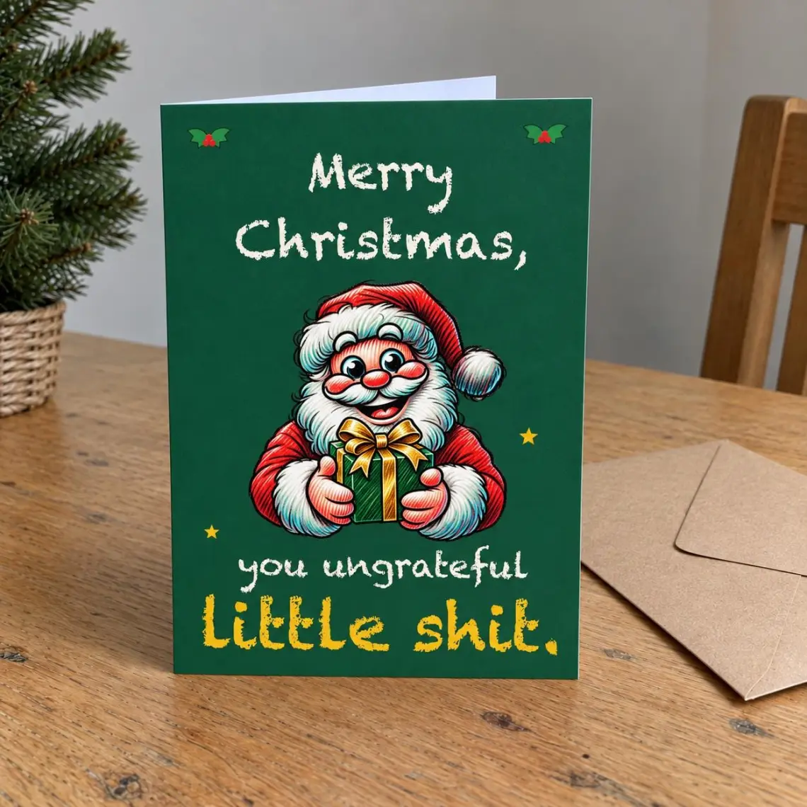Green Christmas card with Santa holding a wrapped present, reading: Merry Christmas, you ungrateful little shit.
