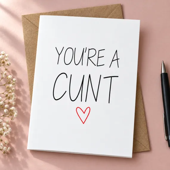 You're a Cunt greeting card with a red heart, shown with a kraft envelope in a lifestyle mock-up